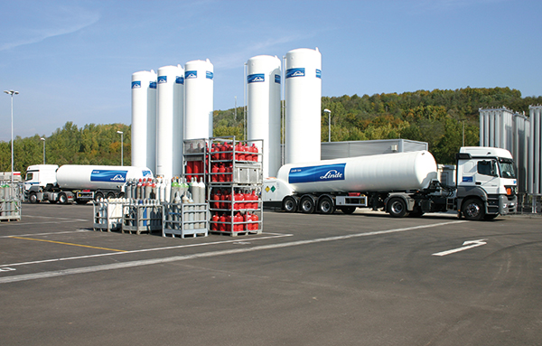 Un camion-citerne est rempli de gaz dans une installation industrielle