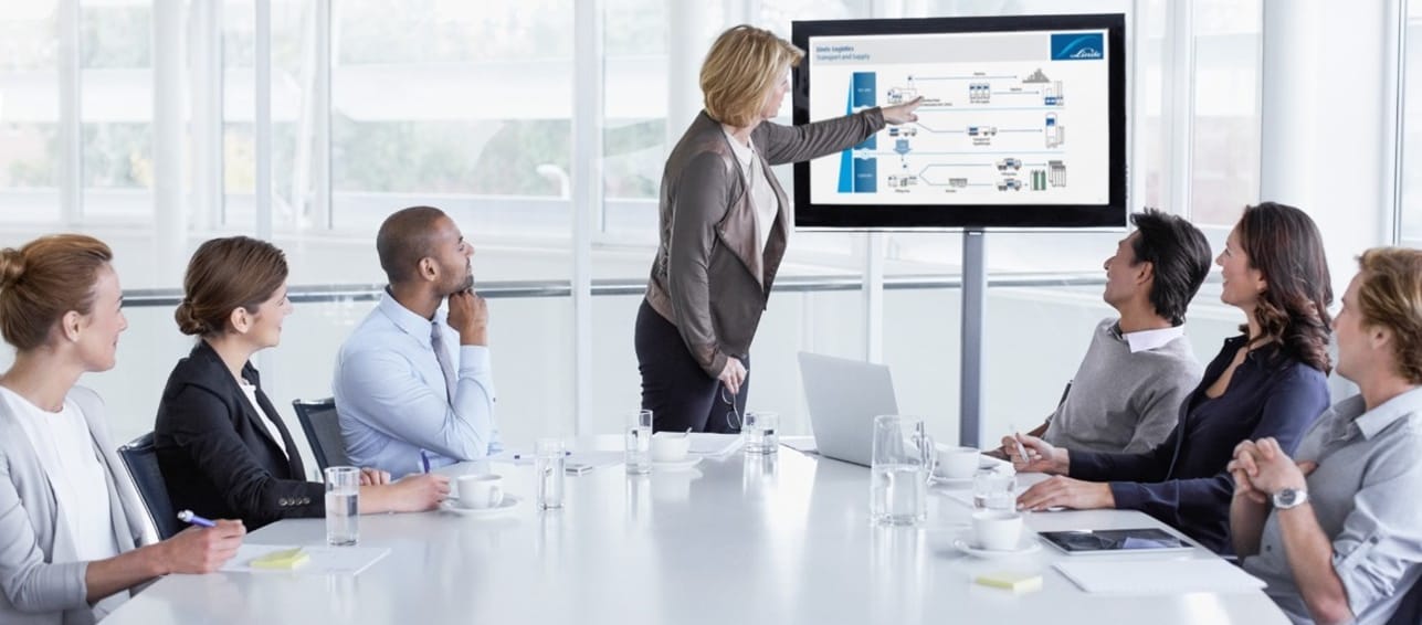 een groep mensen kijkend naar een presentatie van Linde
